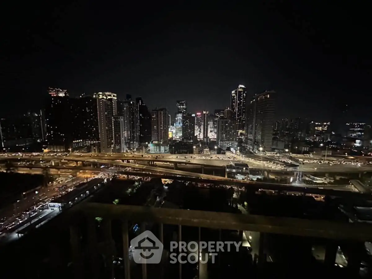 Stunning night cityscape view from a high-rise balcony, showcasing vibrant city lights and skyline.