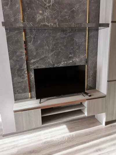 Modern living room with sleek TV stand and marble accent wall