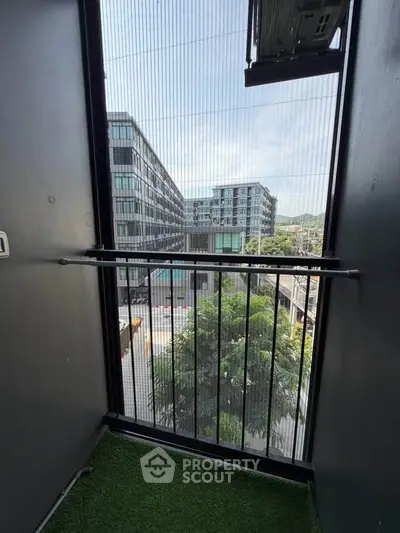 Modern balcony with city view and artificial grass flooring