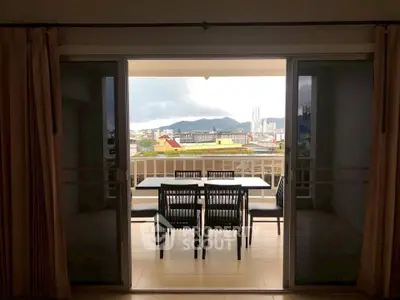 Spacious balcony with dining set offering stunning city and mountain views.