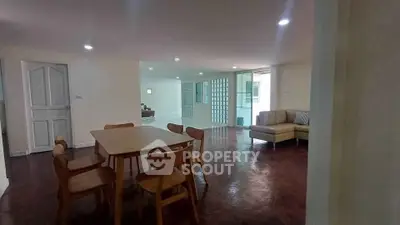 Spacious open-plan living and dining area with modern furniture and ample natural light.