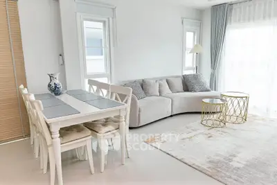 Bright and airy living room with modern decor and elegant dining area.