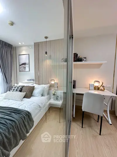 Modern bedroom with study area, featuring elegant decor and natural light, perfect for urban living.