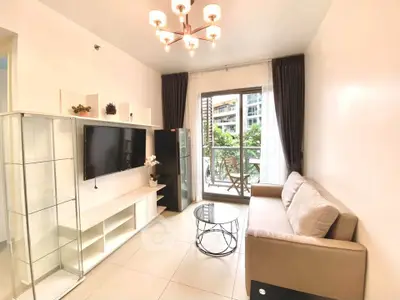 Modern living room with elegant decor and balcony view in a stylish apartment.