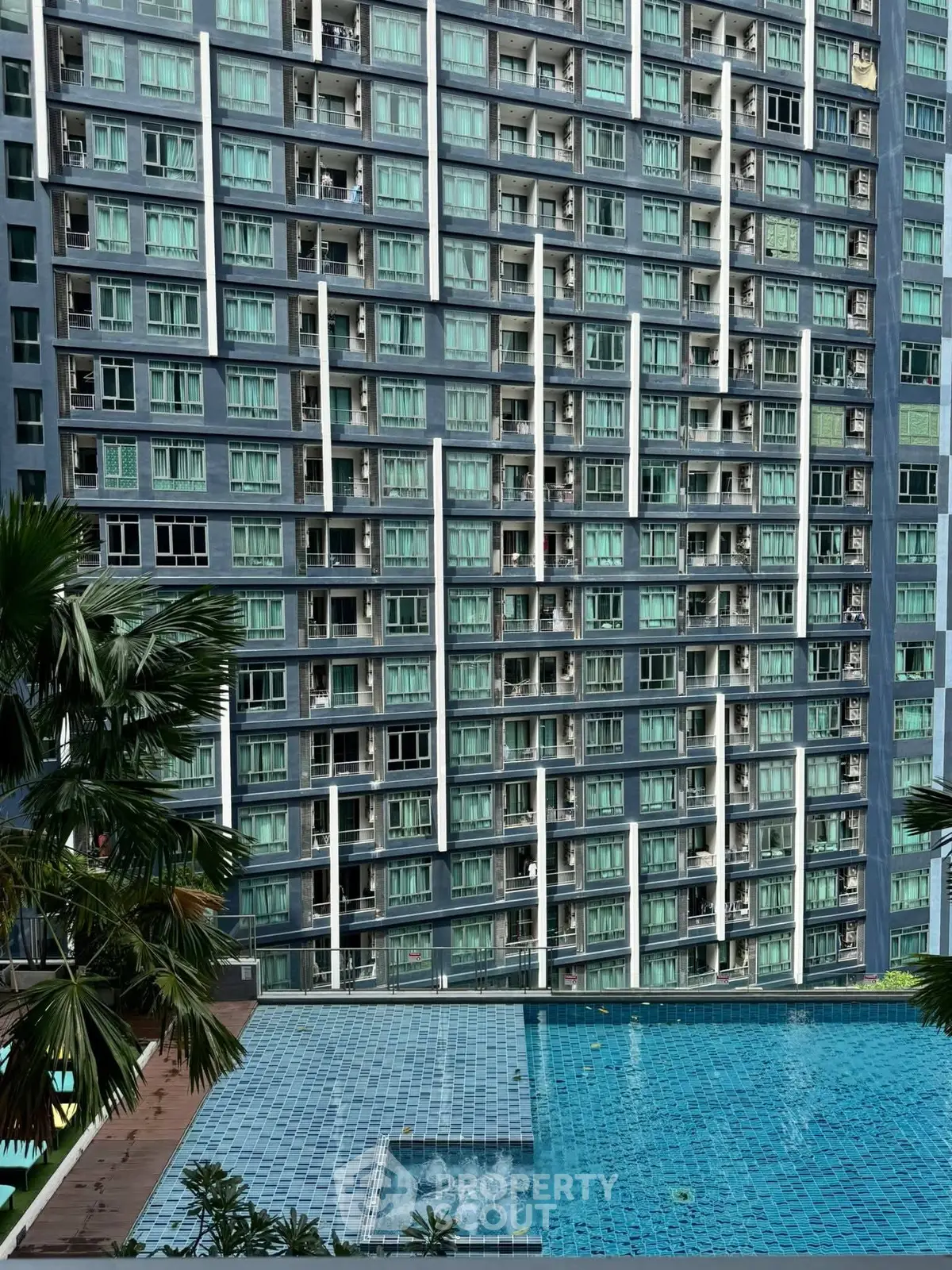 Luxurious high-rise building with stunning pool view and modern architecture.