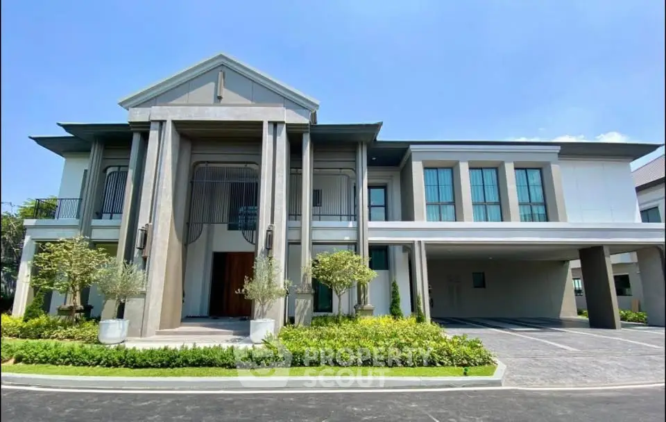 Luxurious modern mansion with grand entrance and manicured landscaping, perfect for upscale living.