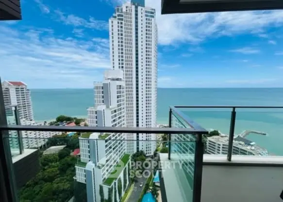 Stunning ocean view from high-rise balcony overlooking modern cityscape.