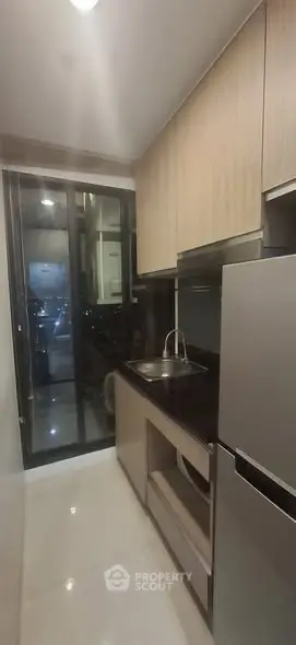 Modern compact kitchen with sleek cabinetry and stainless steel appliances