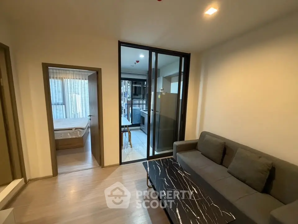 Modern living room with sleek design and open layout, featuring a cozy sofa and stylish coffee table.