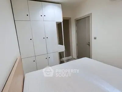 Modern bedroom with built-in wardrobe and minimalist design