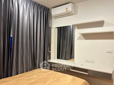Modern bedroom with sleek design, featuring air conditioning and elegant curtains.