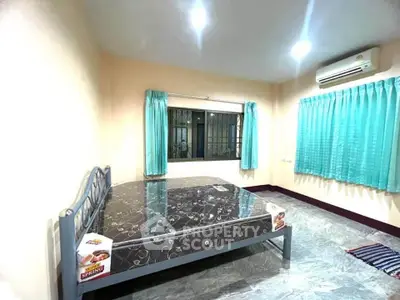 Spacious bedroom with large window and air conditioning