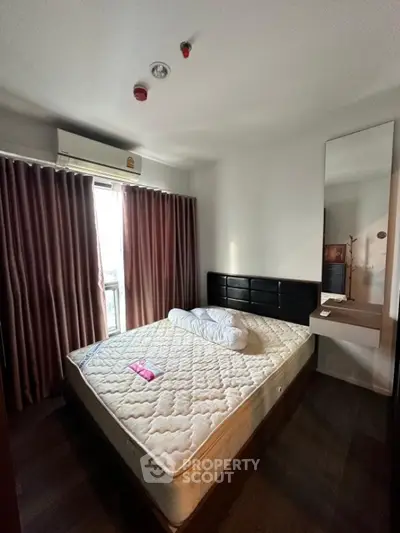 Cozy bedroom with large window and modern furnishings in a stylish apartment