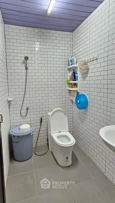 Modern bathroom with white subway tiles and sleek fixtures