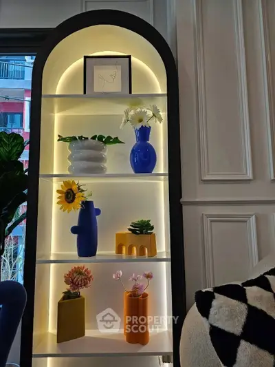 Stylish interior shelf with modern decor and plants, enhancing a cozy living room ambiance.