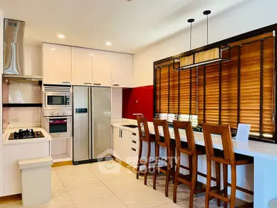 Modern kitchen with sleek appliances and stylish wooden accents