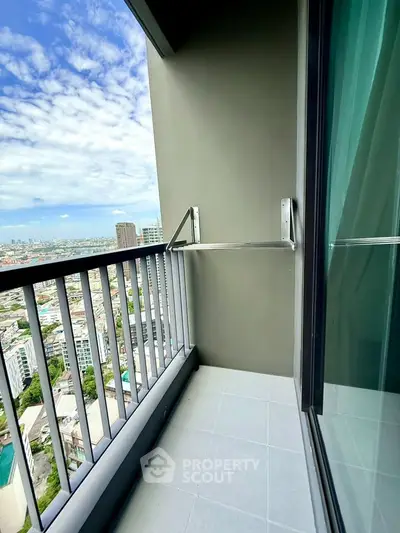 Stunning high-rise balcony with panoramic city views and modern railing design.