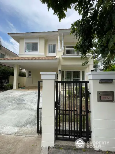 Elegant two-story house with gated entrance and spacious driveway