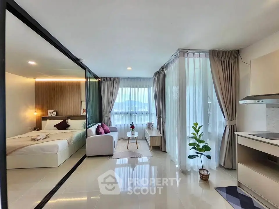 Modern open-plan studio with elegant decor and stunning mountain view.