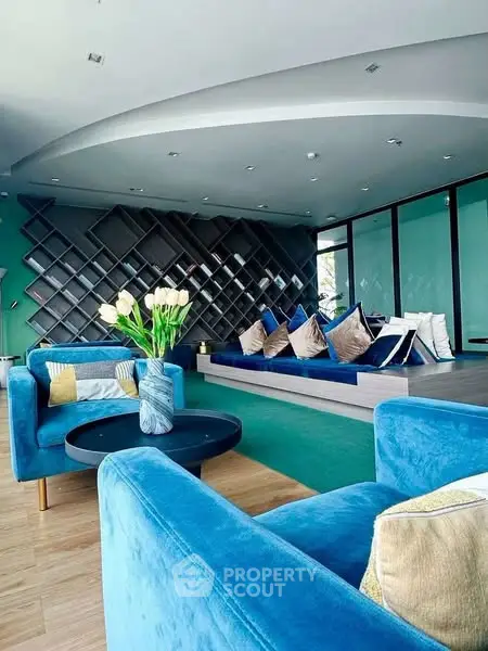 Luxurious modern living room with vibrant blue seating and stylish decor