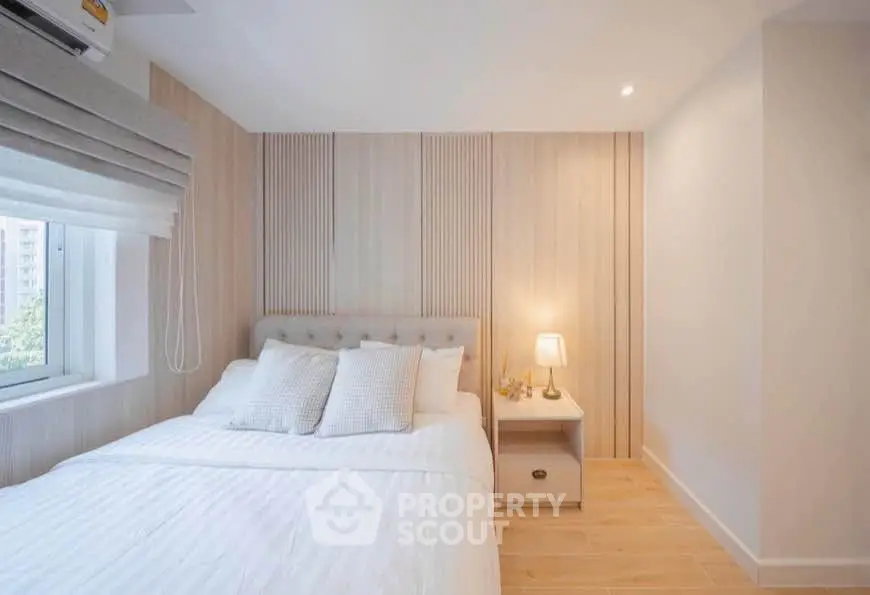 Cozy modern bedroom with elegant wooden paneling and soft lighting