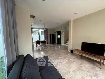 Spacious modern living room with sleek furniture and large windows