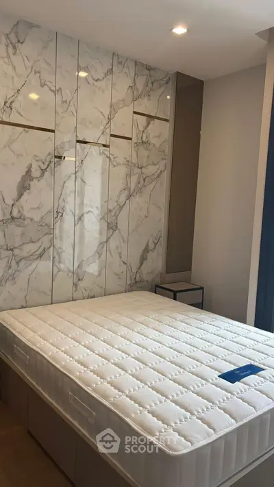 Luxurious bedroom with marble accent wall and modern design