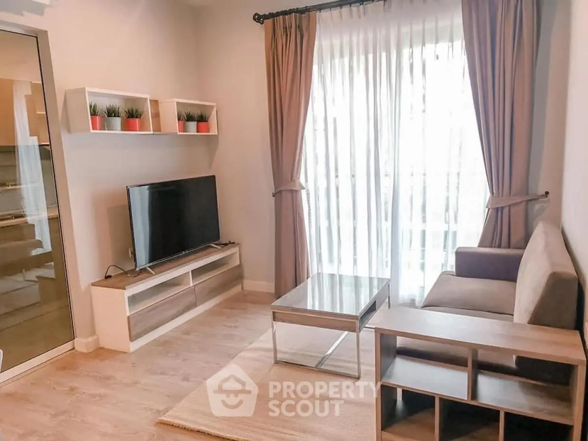 Modern living room with natural light, stylish furniture, and elegant decor.