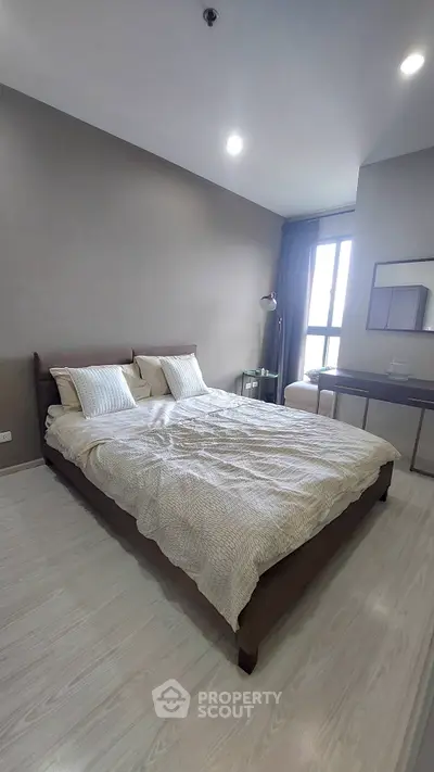 Modern bedroom with cozy bed and stylish decor in a contemporary apartment.
