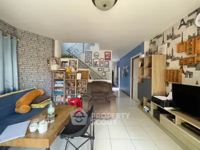 Charming living room with modern decor and cozy seating area, perfect for relaxation and entertainment.