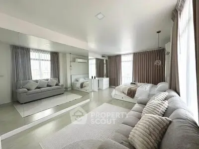 Spacious modern living room with large mirror and cozy seating area