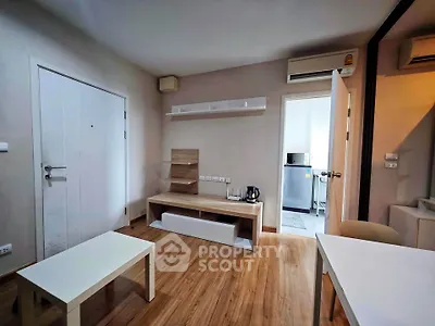 Modern living room with wooden flooring and minimalist furniture in a cozy apartment.