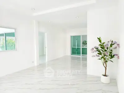 Spacious modern living room with elegant marble flooring and natural light