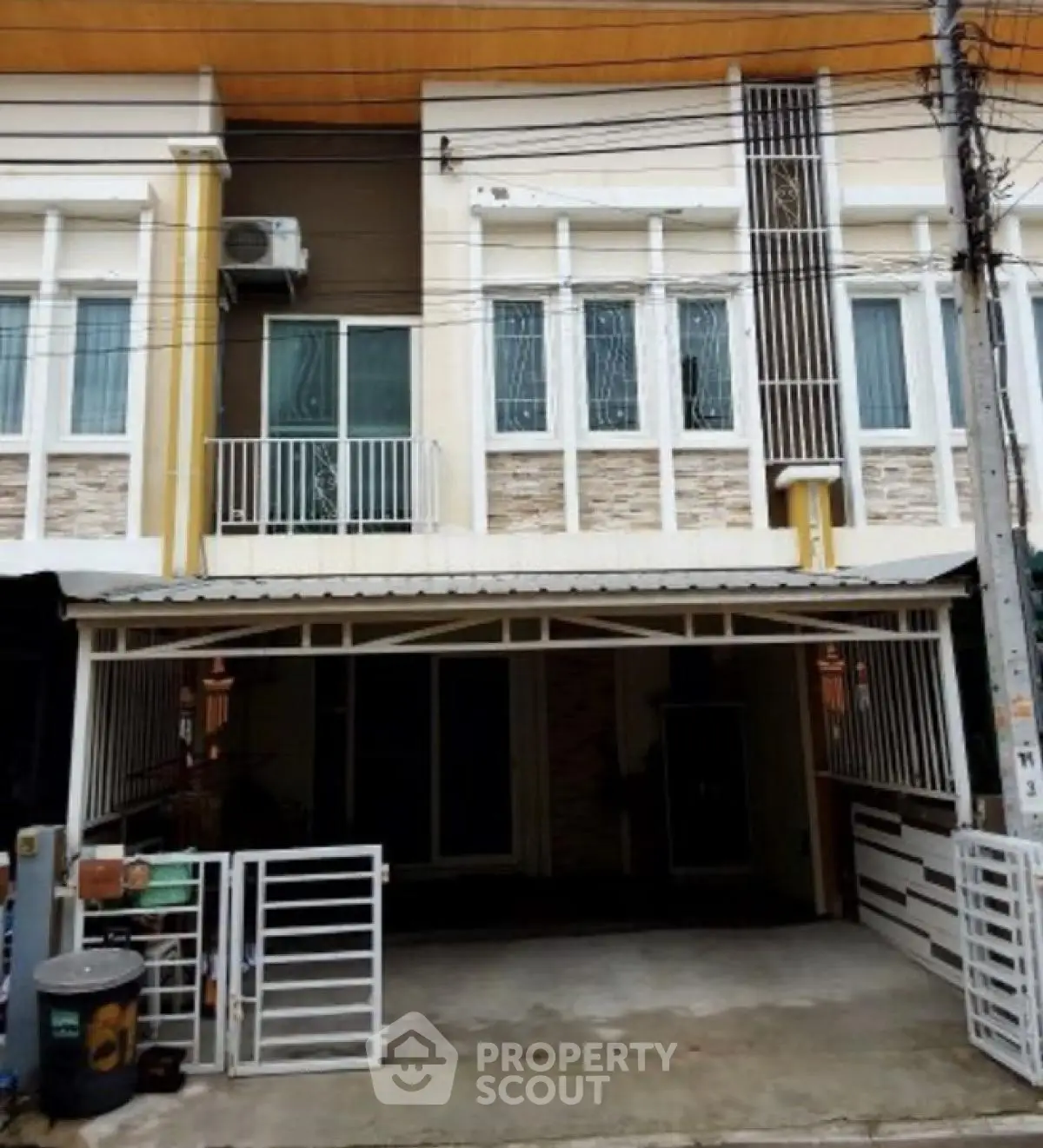 Modern townhouse exterior with gated parking and contemporary design