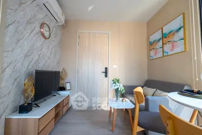 Cozy living room with modern decor and natural light, featuring a stylish sofa and wall art.