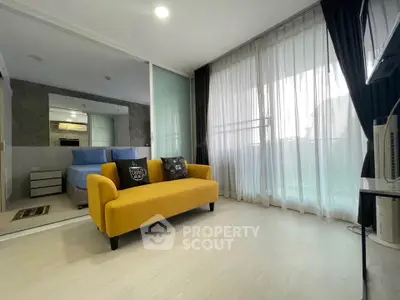 Modern living room with yellow sofa and large window, featuring stylish decor and ample natural light.