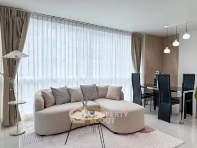 Elegant living room with modern furniture and large windows in a stylish apartment.