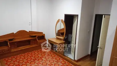 Spacious bedroom with wooden furniture and unique tile flooring