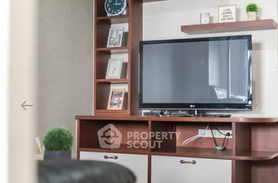 Modern living room with stylish wooden TV stand and decor accents