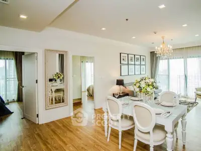 Elegant open-plan living and dining area with chic decor and large windows for natural light.
