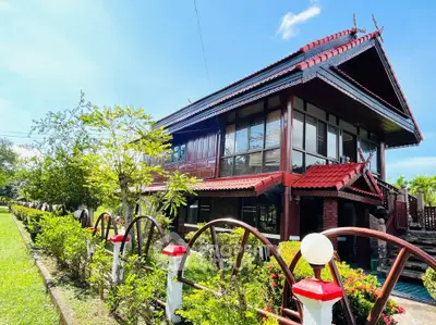 Charming traditional-style house with lush garden and unique architectural design.