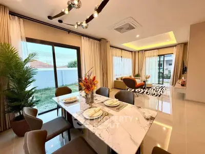 Luxurious open-plan living and dining area with modern decor and large windows.
