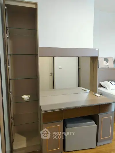 Modern bedroom with sleek vanity and storage shelves, ideal for stylish living.