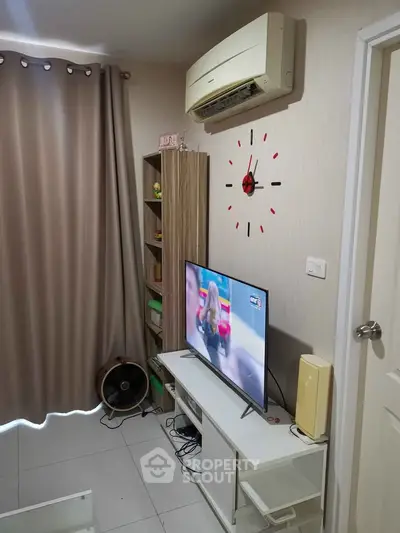 Cozy living room with modern decor and wall-mounted air conditioning unit.