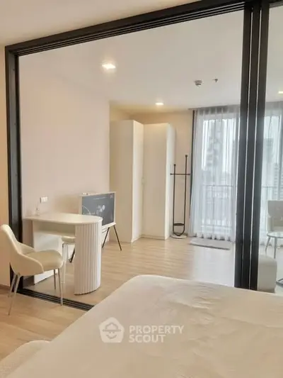 Modern bedroom with glass partition and stylish furniture in a contemporary apartment.