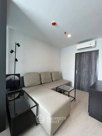 Modern living room with sleek furniture and minimalist design in a contemporary apartment.