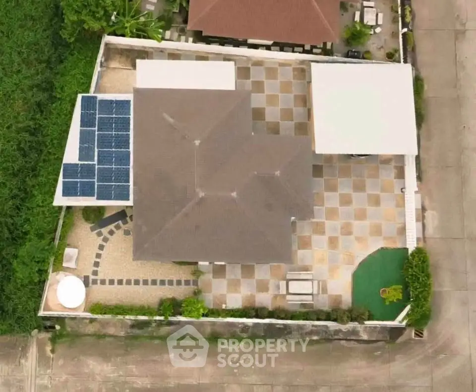 Aerial view of modern house with solar panels and spacious patio