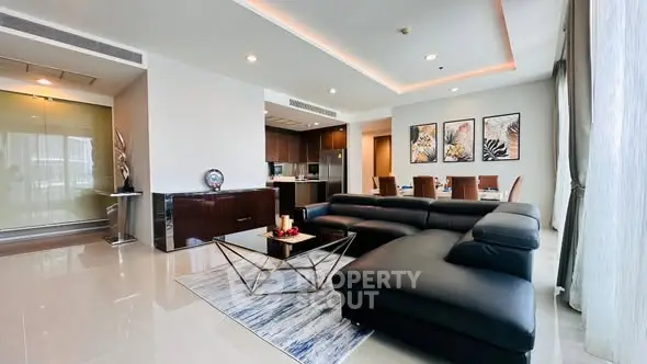Luxurious modern living room with sleek black sectional sofa and elegant dining area in open layout.