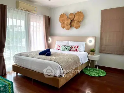 Cozy bedroom with stylish decor and natural light, featuring a comfortable bed and modern furnishings.