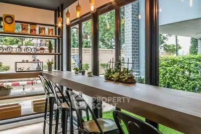 Stylish modern interior with large windows and chic decor, perfect for relaxation and entertaining.